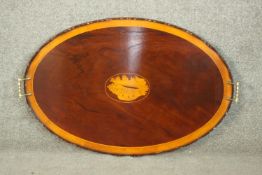 A late Victorian style mahogany oval twin handled galleried tray with sea shell motif to centre. L.