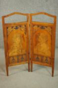 An Edwardian marquetry inlaid two fold screen, both panels with portraits of children holding