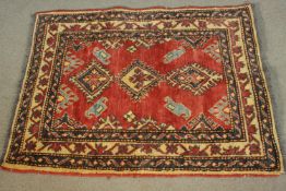 A hand made red ground Chechen rug. L.106 W.84cm.