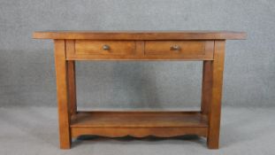 A Continental hardwood sideboard, the rectangular top over two short drawers, on square section legs