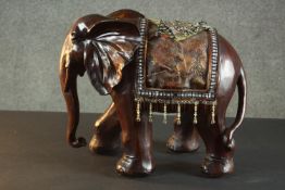 A moulded carved effect Elephant with blanket with beaded decoration. H.52 W.46 D.24cm.