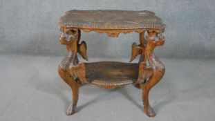 A late 19th century oak occasional table with shaped and carved central medallion raised on
