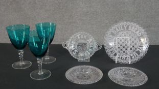 A collection of glass, including three turquoise wine glasses with clear twist stems and some