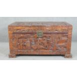 A 20th century Chinese camphorwood coffer, of rectangular form, the lid and sides ornately carved