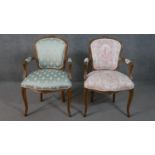 A pair of French walnut Louis XV style fauteuil armchairs, upholstered in differing fabric, with