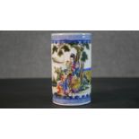 A 19th century Chinese hand painted porcelain brush pot, decorated with figures in a mountainous