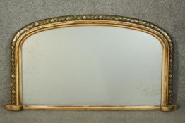 A Victorian giltwood overmantel mirror, of rounded arch form, with a painted floral border. H.51 W.