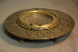 A 19th century brass studded design warming table, with brass wrapped timber frame with carved legs.