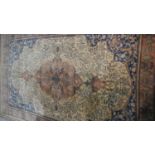 A Persian style carpet with central medallion and tree of life motifs on a biscuit ground