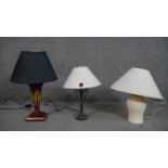 Three table lamps, including a painted and gilded table lamp, a wrought iron scrolling design lamp