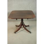 A George III mahogany dining table, the rectangular top with rounded corners and reeded edges, on