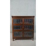 A 20th century Minty of Oxford three tier stacking bookcase, each tier with two leaded glass