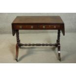 A George III design mahogany sofa table, the top with two drop leaves over two short drawers, on