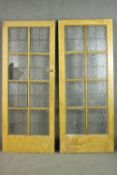 A pair of vintage simulated oak doors, lead set with textured glass panels, the reverse of one