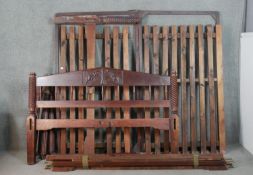 An Indian hardwood double four poster bed, with four wrythen columns, the headboard with a reserve