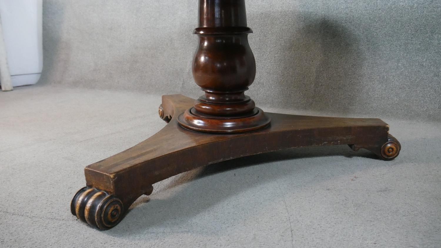A Victorian circular mahogany tilt top breakfast table, with a turned stem, on a tri-form base - Image 3 of 5