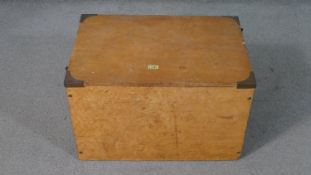 A stained hardwood lidded box with brass fittings containing eight maple veneered framed