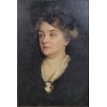 A framed giltwood and gesso framed oil on canvas of an elderly Victorian lady in black with cameo