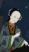 A framed early 20th century Chinese reverse painting on glass of a courtesan in traditional robes.