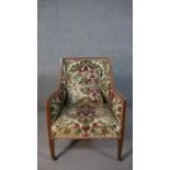 An Edwardian mahogany armchair, upholstered in foliate Victorian style fabric, on square section