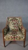 An Edwardian mahogany armchair, upholstered in foliate Victorian style fabric, on square section