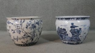 Two Oriental style blue and white ceramic planters/gold fish bowls, one with a Chinese landscape
