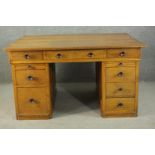 An early to mid 20th century oak pedestal desk, with three short drawers, over two slides, above two