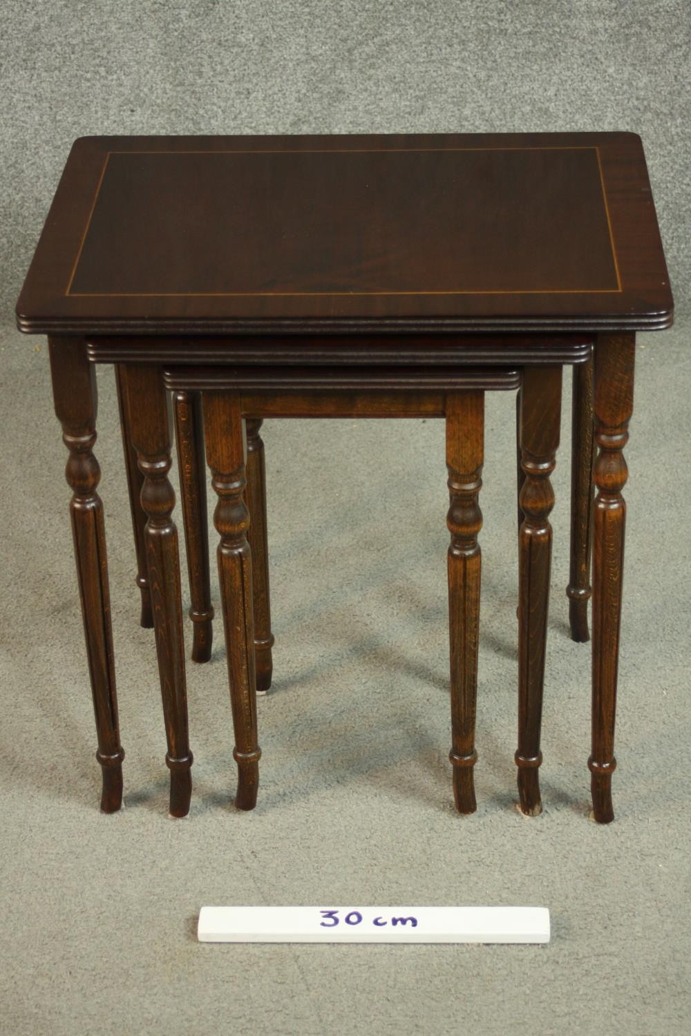 A reproduction mahogany and beech nest of three tables, with rectangular tops on turned and fluted - Image 2 of 7