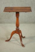 A 19th century walnut occasional table, with a folding rectagular top, on a turned baluster stem,