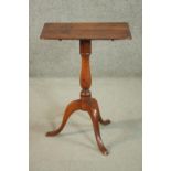 A 19th century walnut occasional table, with a folding rectagular top, on a turned baluster stem,