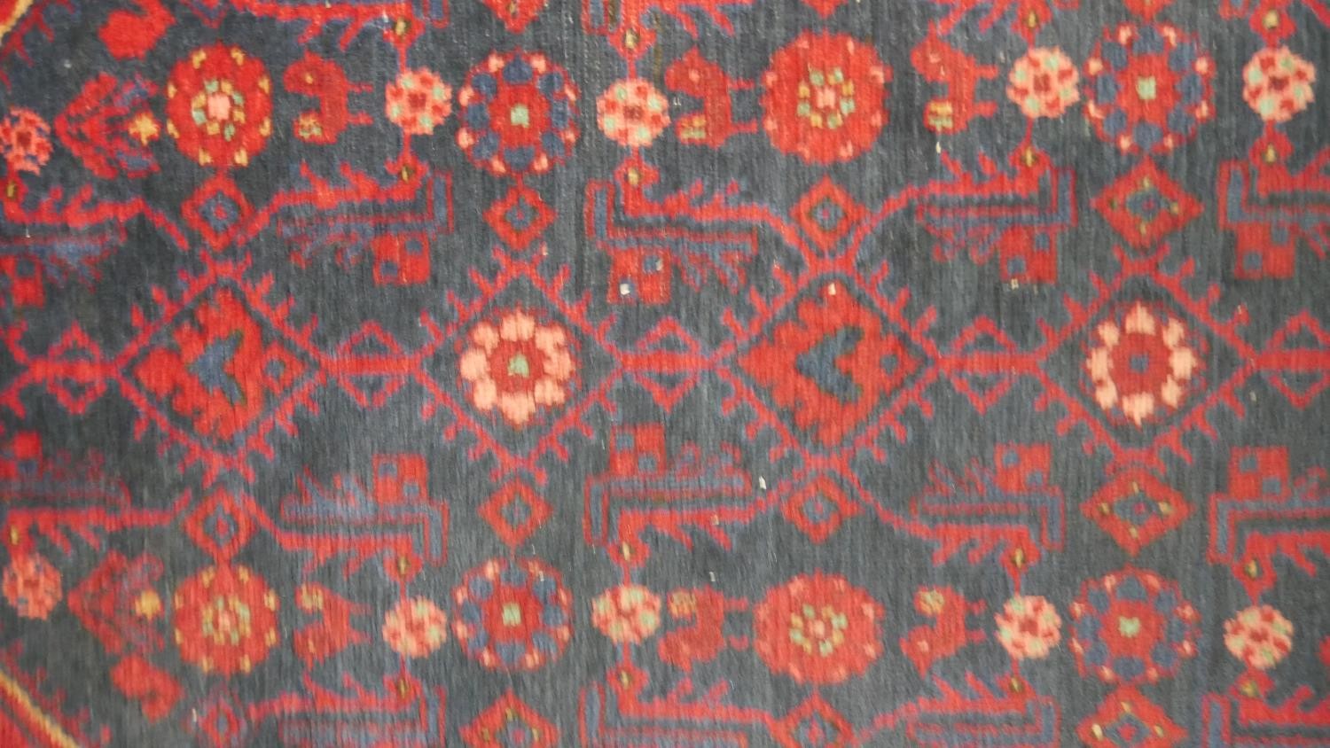 A Persian Hamadan rug with stylised hooked design on a midnight ground. L.170 W.110cm - Image 3 of 4