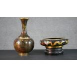 A Japanese cloisonné enamel floral design brass vase along with a dragon design bowl on carved and