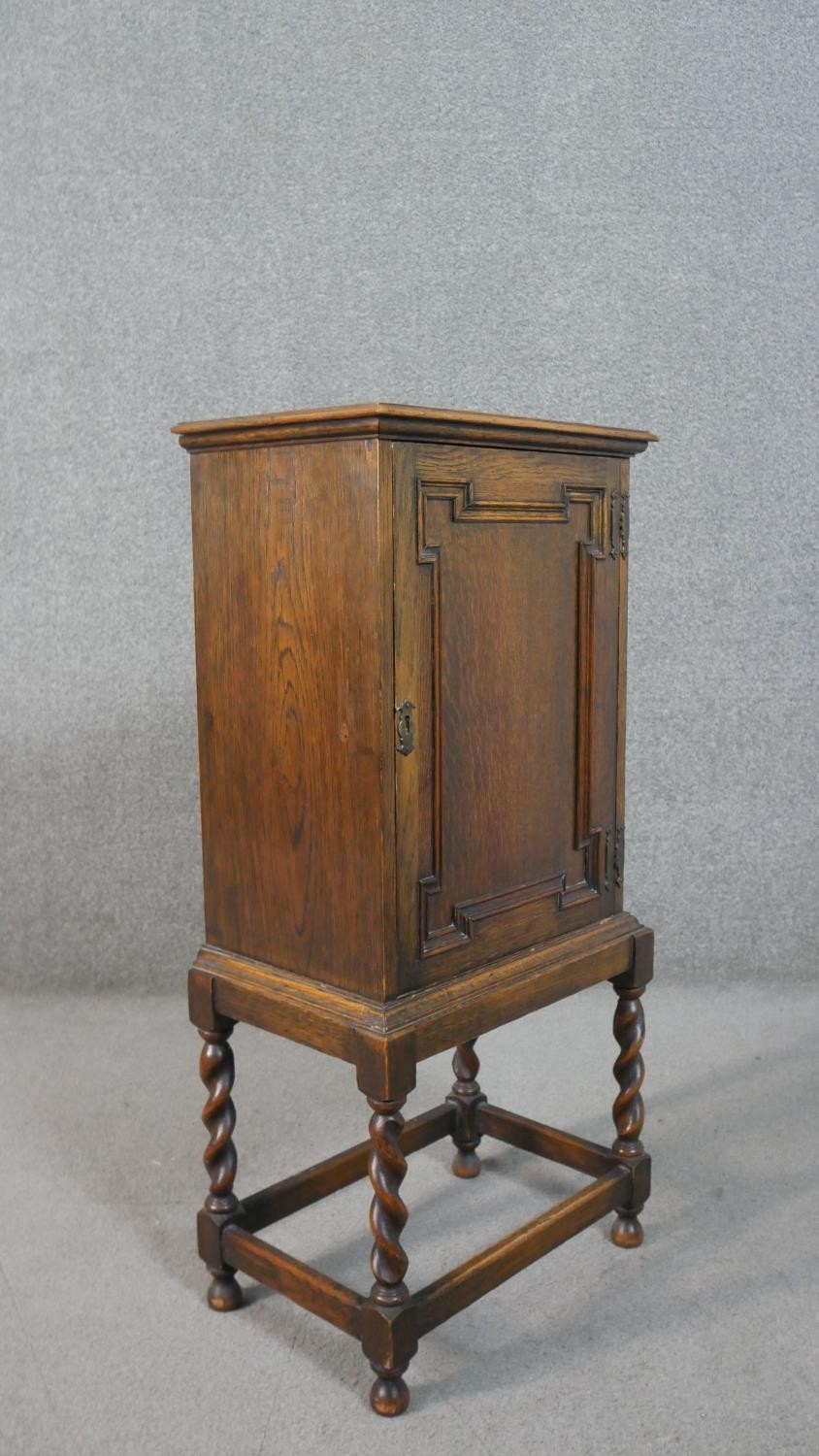 A Jacobean style oak cabinet with lozenge panel door enclosing a fitted interior on a barleytwist - Image 2 of 7