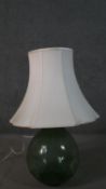 A large green blown glass demijohn converted into a lamp. H.90cm