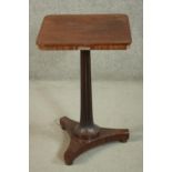 A Regency mahogany occasional table, the square top with rounded corners, on a fluted stem, over a