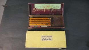 A boxed vintage superior price marker printing set along with a boxed set of vintage Columbia