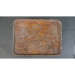 A Chinese early 20th century carved and stained tray decorated with a landscape scene with a