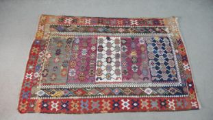 A flatweave Kelim rug with all over polychrome stylised design. L.180 W.120cm