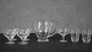 A collection of engraved glassware, including a set of four fern design dessert bowls, two floral