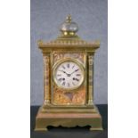 A 19th century tri-metal Egyptian relief design mantle clock of architectural form. Brass movement