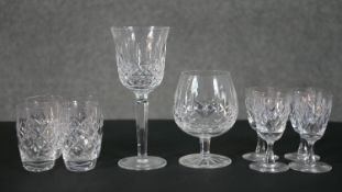 A collection of crystal drinking glasses, including a set of four sherry glasses, a set of four