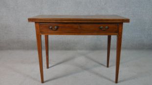 A late 19th century mahogany tea table, with a foldover top above a single long drawer, on square