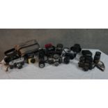 A collection of approximately sixteen vintage cameras, lenses and accessories including an Asahi