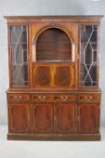 A George III style reproduction mahogany side cabinet, with a dentil cornice over a rounded arched