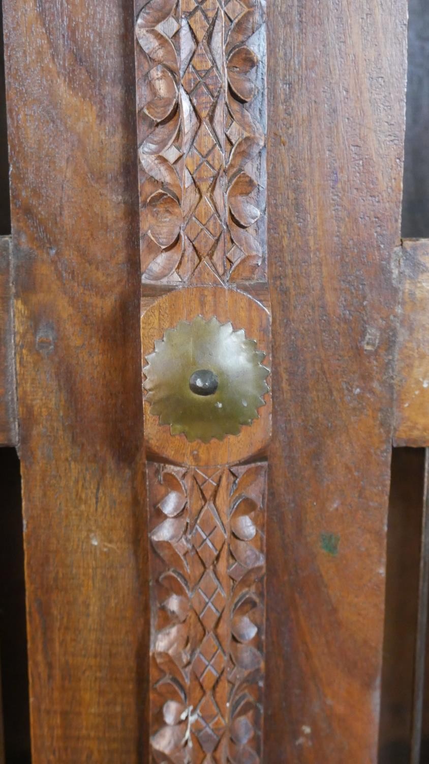 A 20th century Indian sheesham bookcase, the two doors with metal spindle panels, opening to - Image 4 of 8