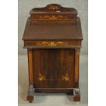 An Edwardian rosewood Davenport, the superstructure with a rising lid and fitted interior, over a