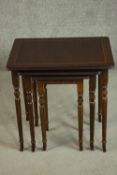 A reproduction mahogany and beech nest of three tables, with rectangular tops on turned and fluted