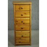 A late 20th century pine tall slender chest, of five drawers with knob handles. H.108 W.44 D.39cm.