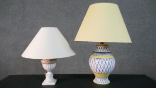 Two hand painted ceramic table lamps, one with a blue and yellow geometric design and the other with