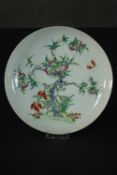A Famille Rose Chinese porcelain nine peaches plate, decorated with lucky bats, grapes and a peach